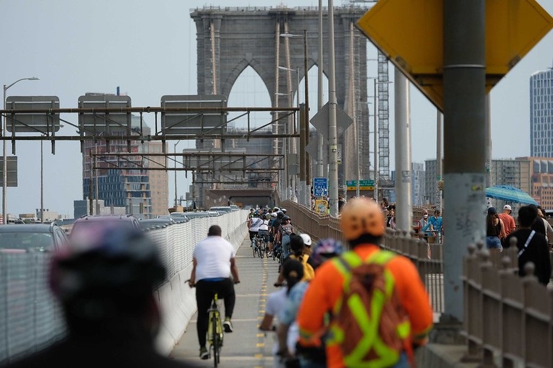 Cyclists biking across the Brooklyn Bridge